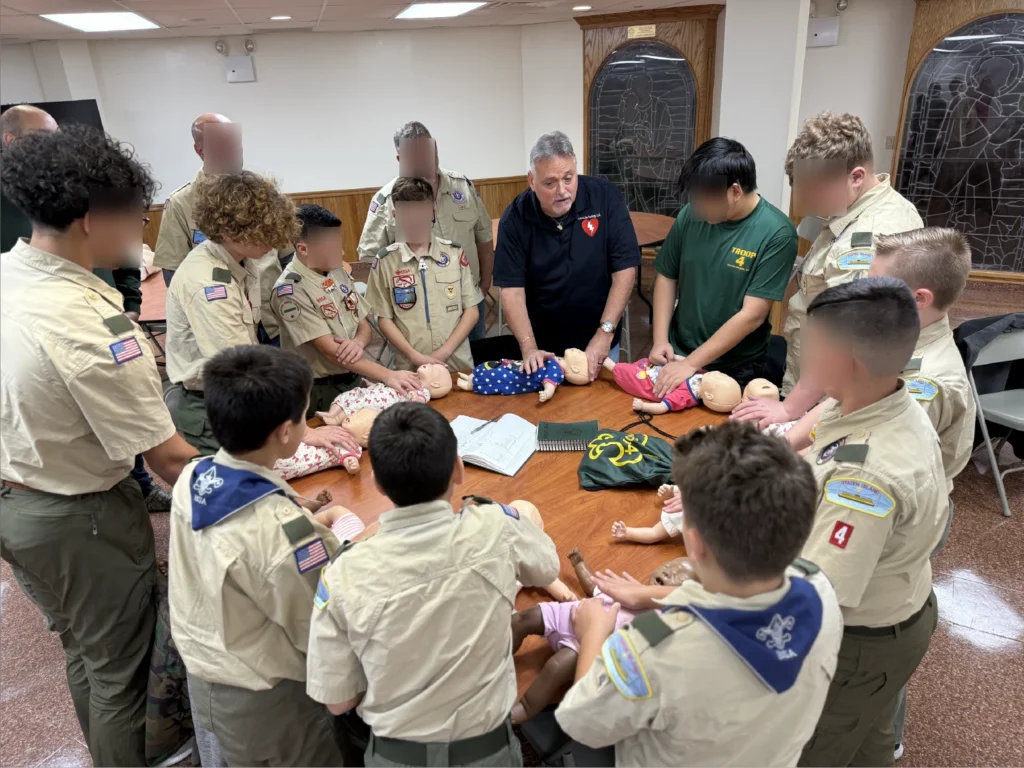 CPR instructor guiding students while demonstrating CPR techniques on a training class