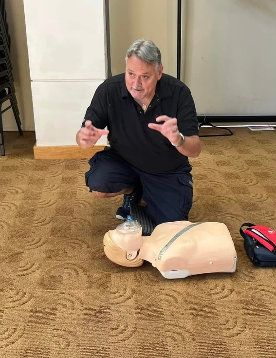 Instructor demonstrating CPR on a training mannequin